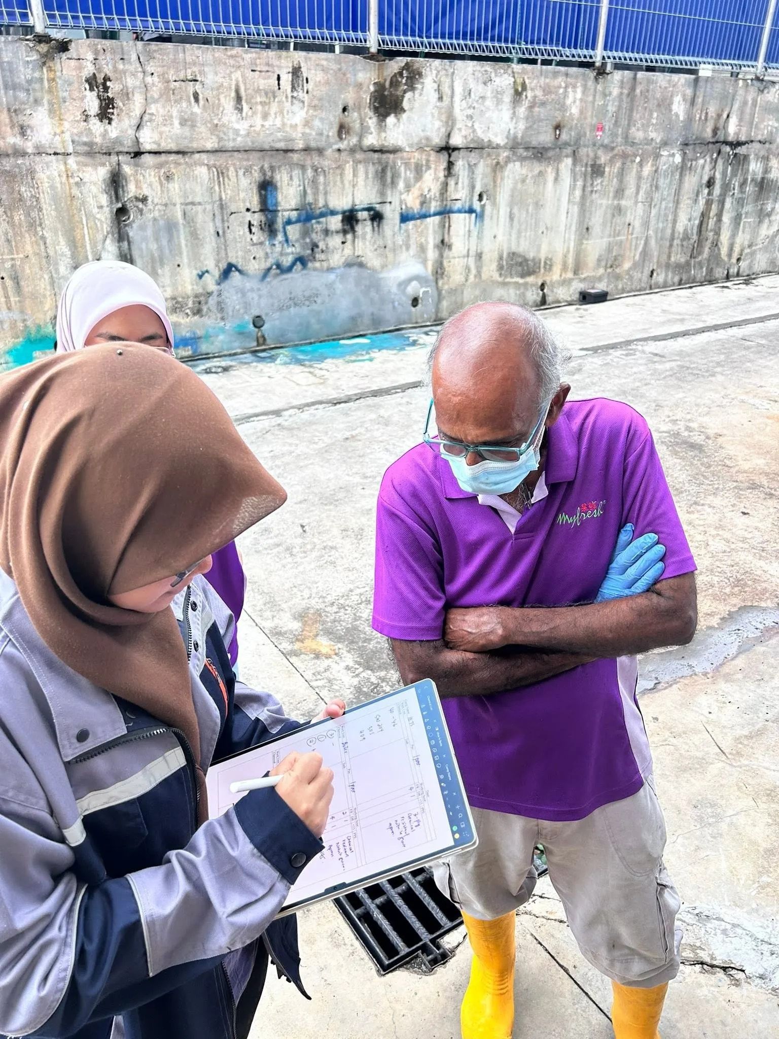 An assessor recording findings on site during a premises inspection